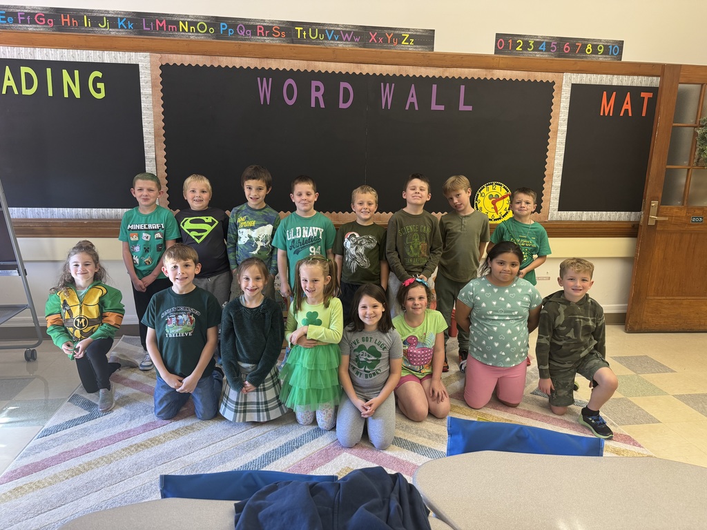 a group of students all wearing green