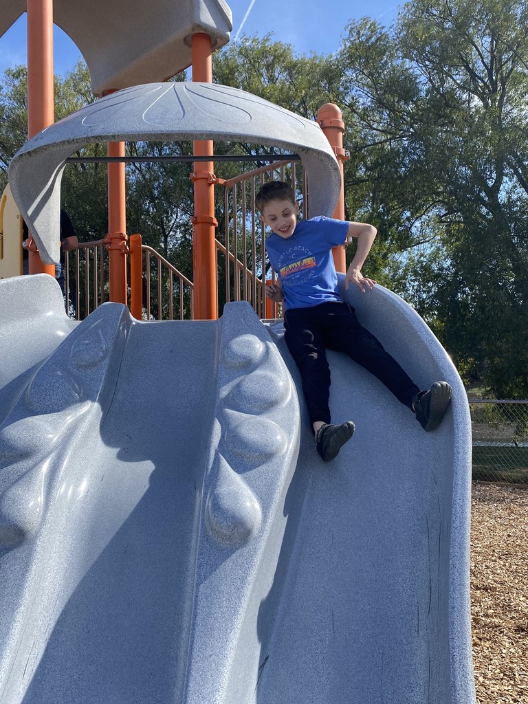 boy sliding down slide