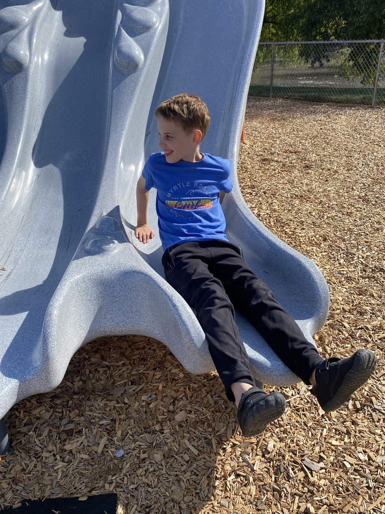 boy at bottom of slide