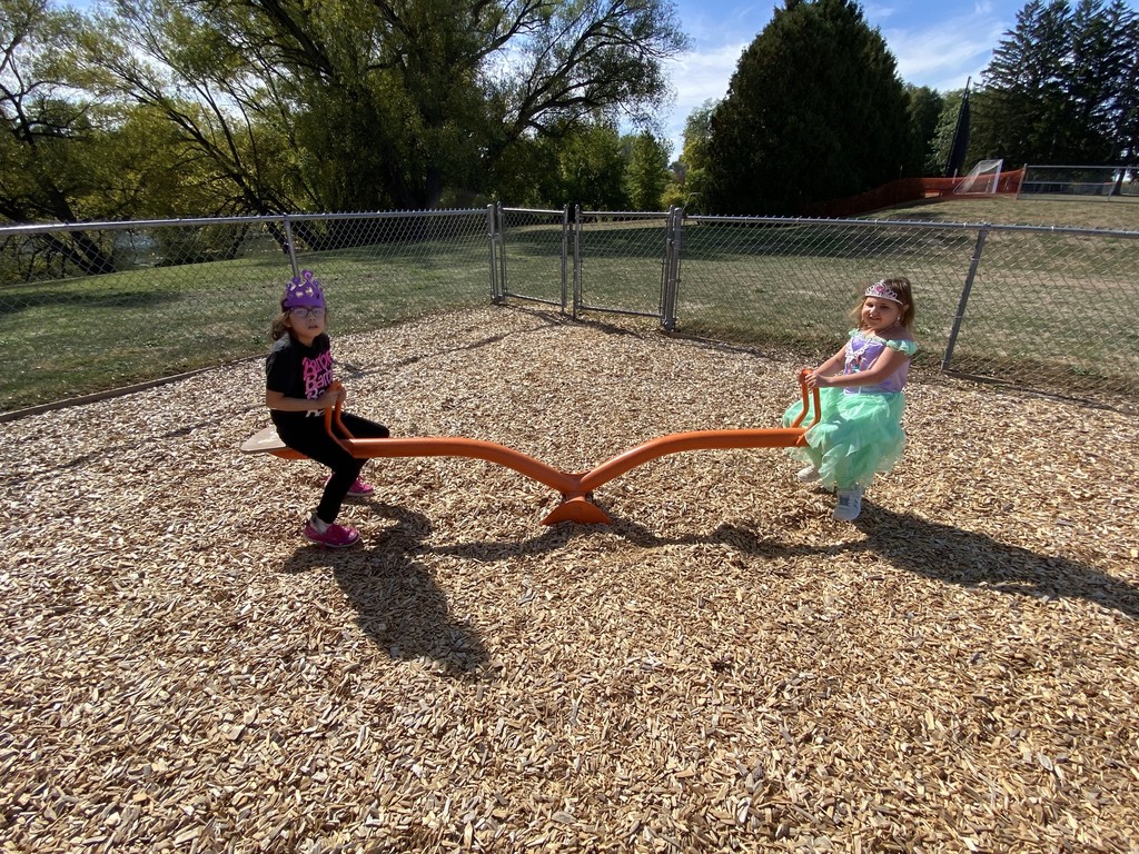 two girls on teetertotter on playground