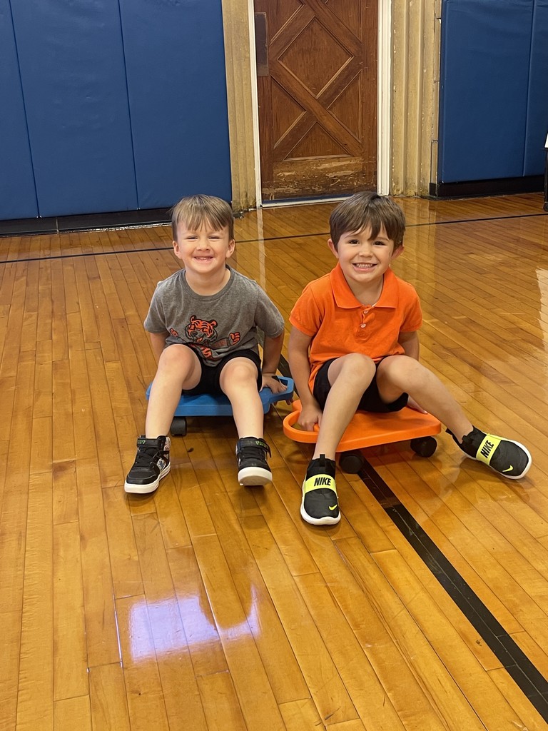 two boys sitting on scooters