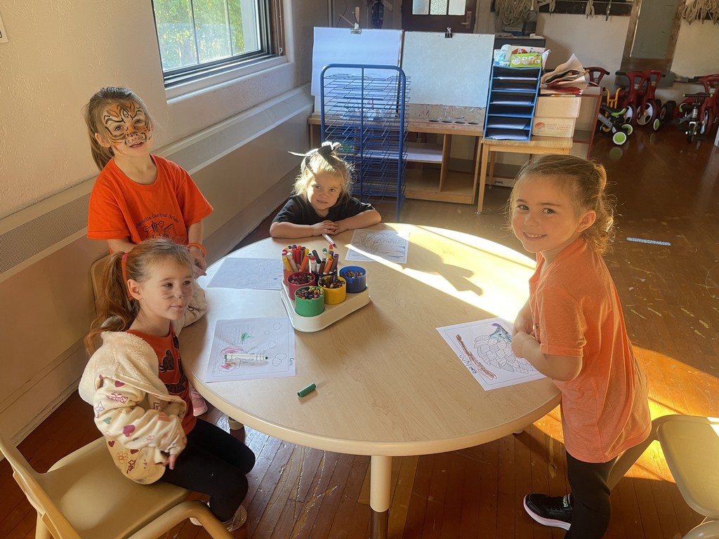 four students sitting at table
