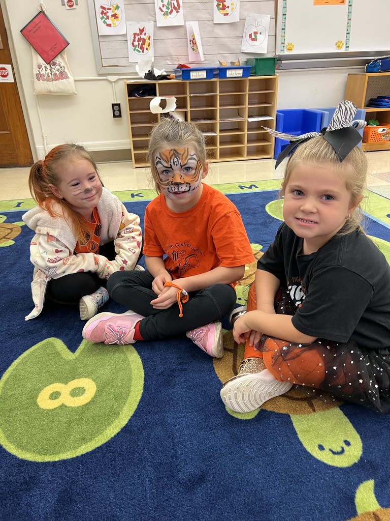 three girls sitting on rug