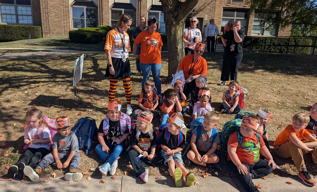 students and staff showing off their school spirit outside