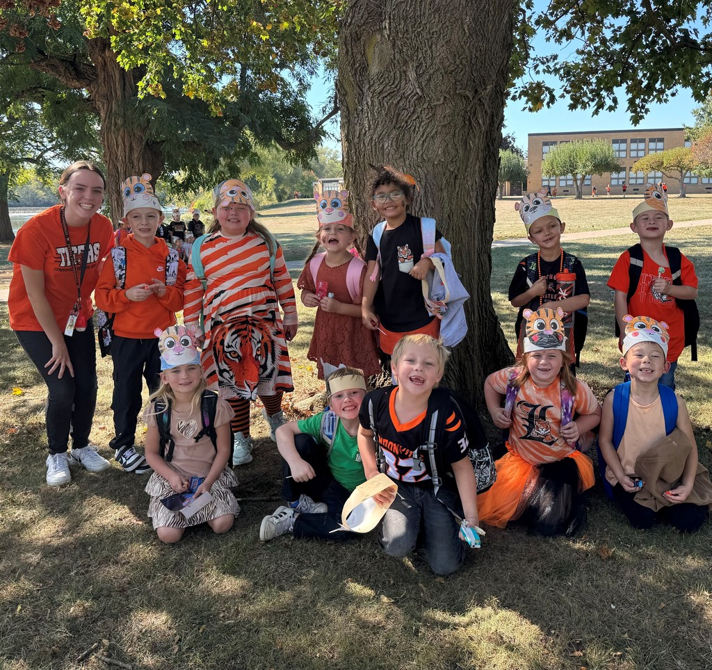 students and teacher outside showing off school colors