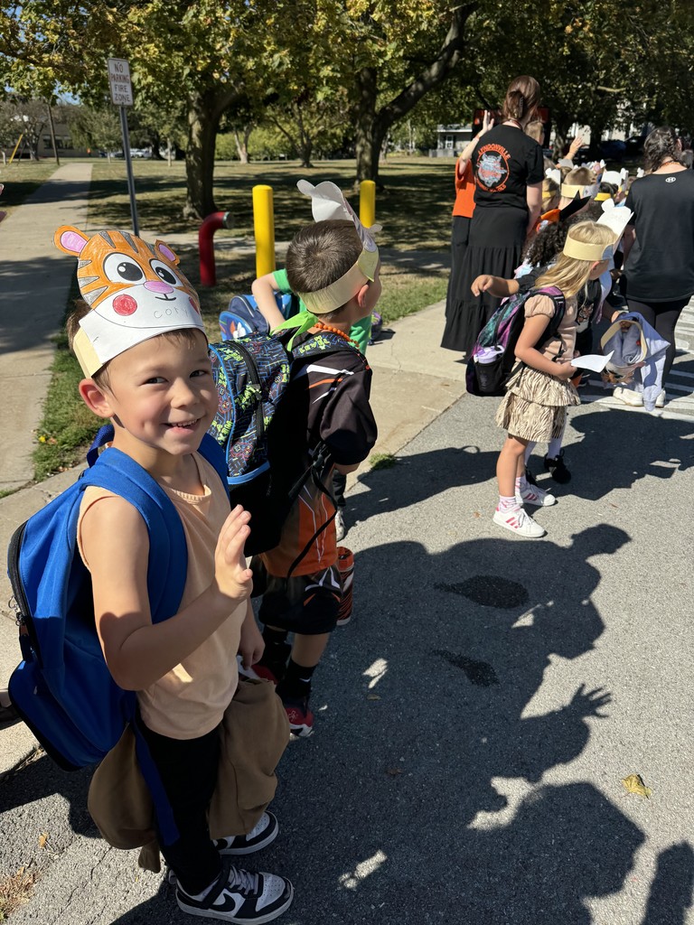 students standing on sidewalk waiting for parade