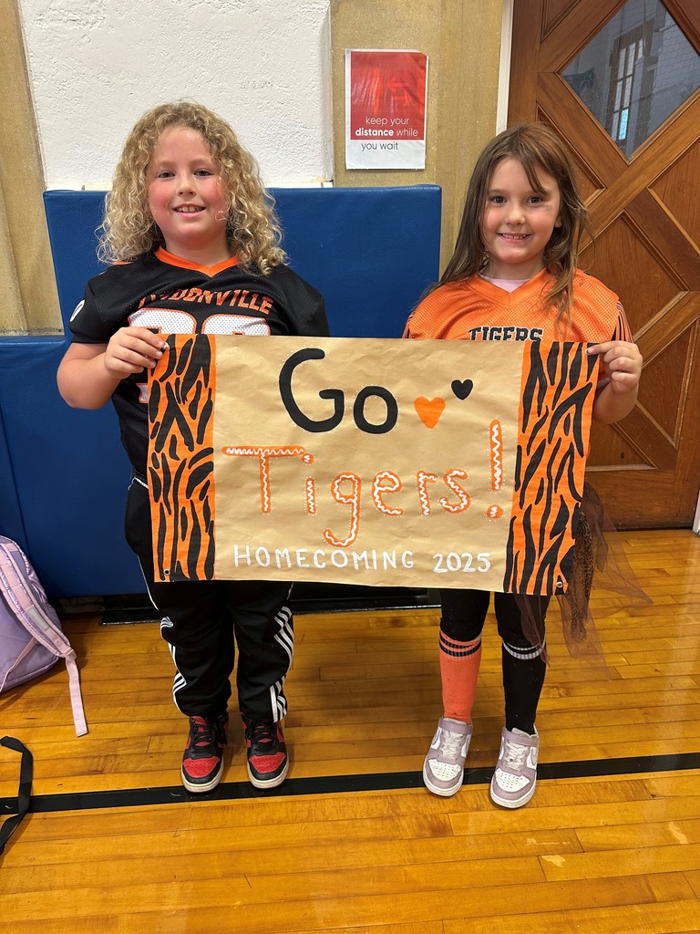 two students holding a sign