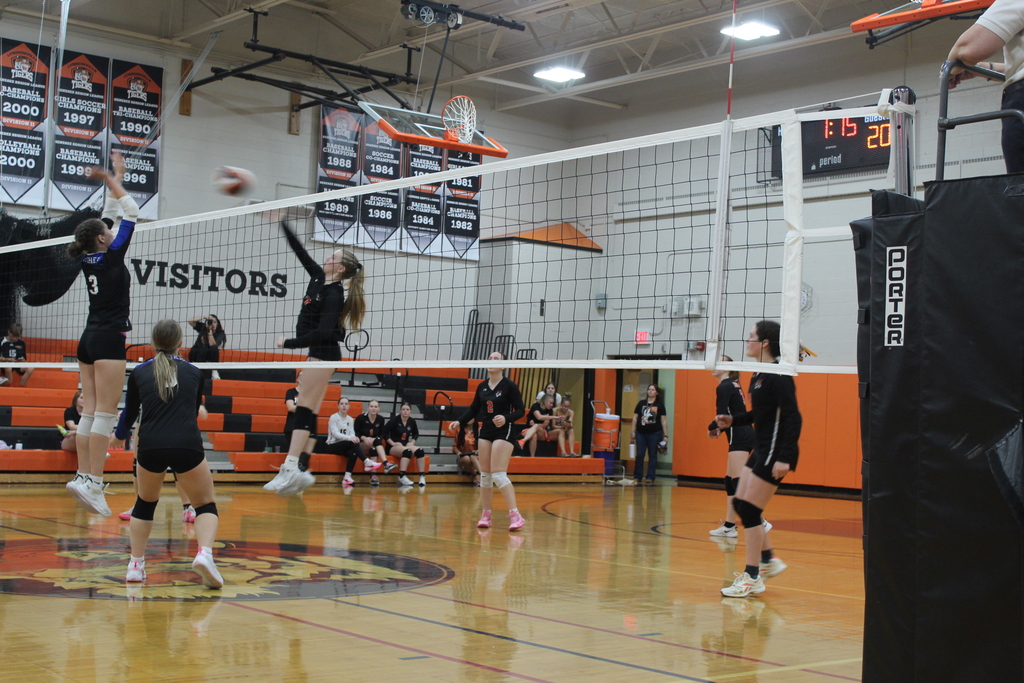 girls playing volleyball in gym