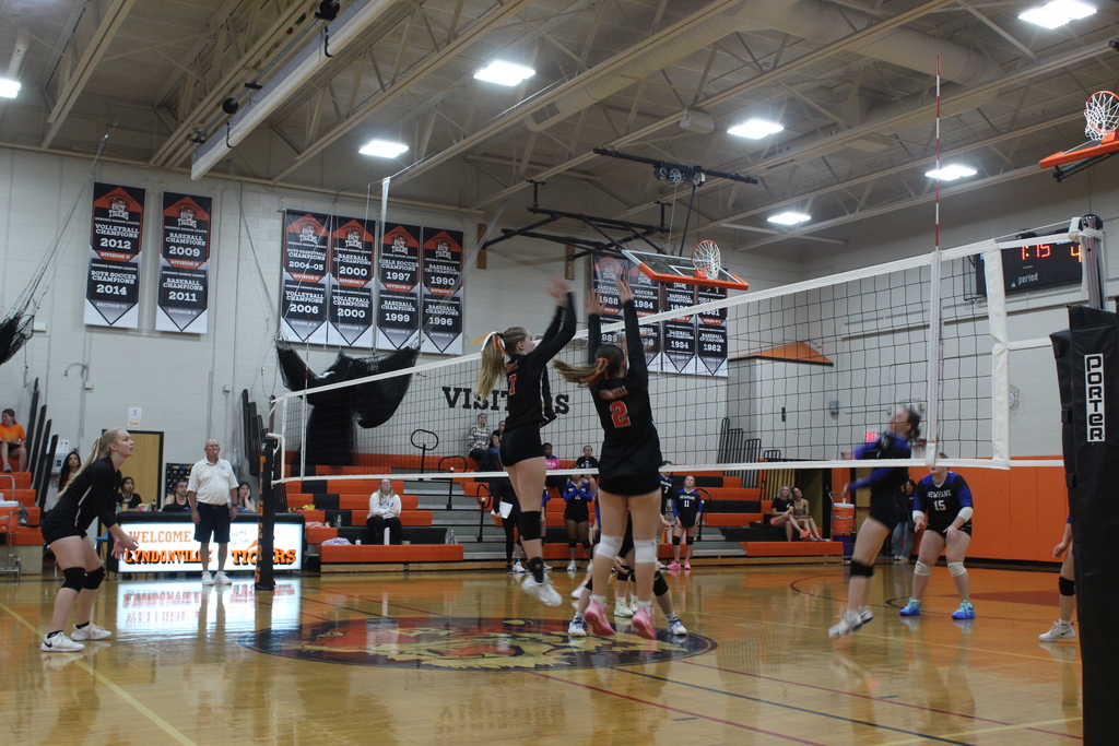girls playing volleyball in gym