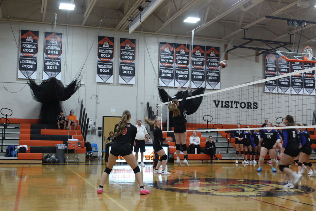 girls playing volleyball in gym