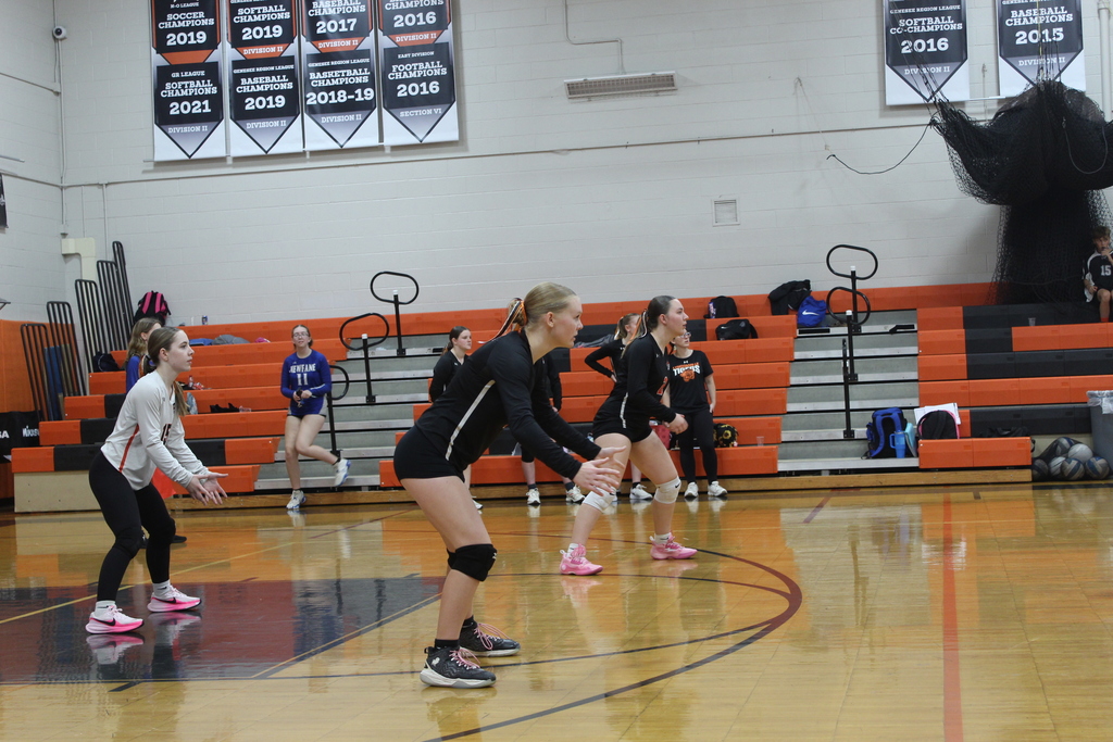 girls playing volleyball in gym