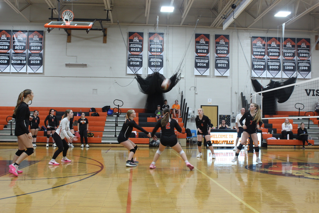 girls playing volleyball in gym