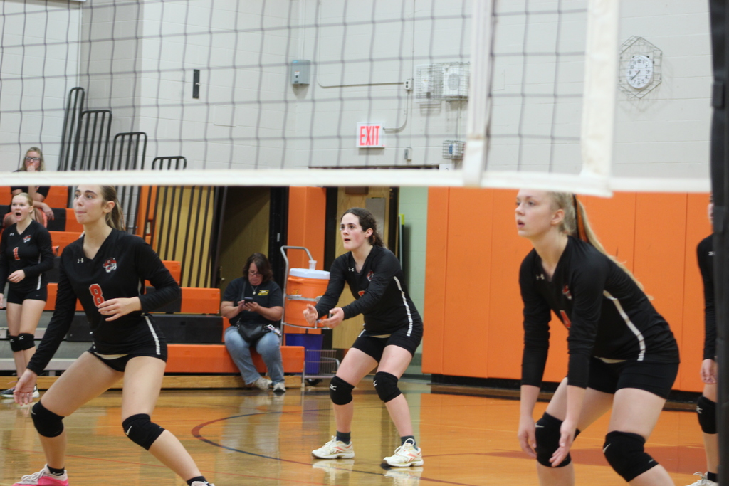 girls playing volleyball in gym