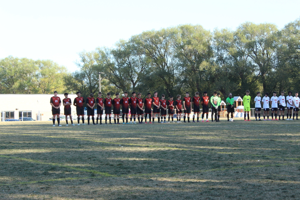 boys varsity soccer team lined up on the field