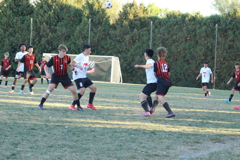 boys playing soccer on field