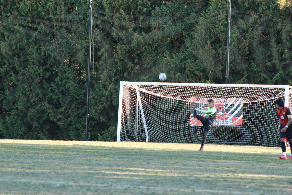 goaling kicking ball away from goal