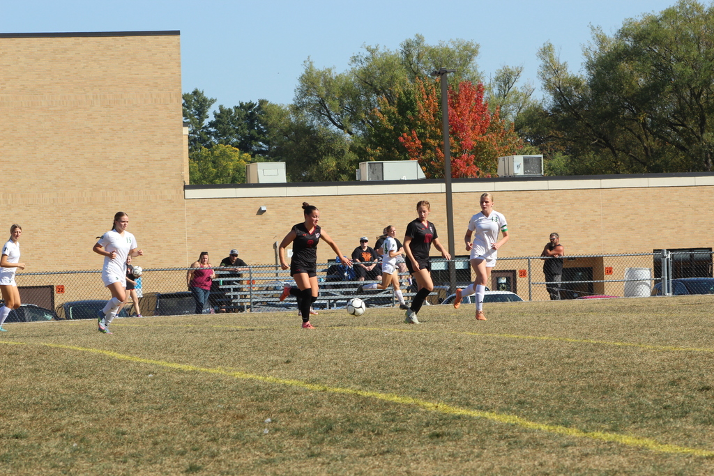 girls playing soccer on the field