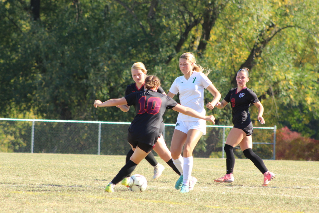 girls playing soccer on the field