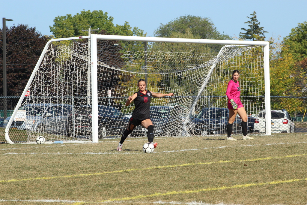 girls playing soccer on the field