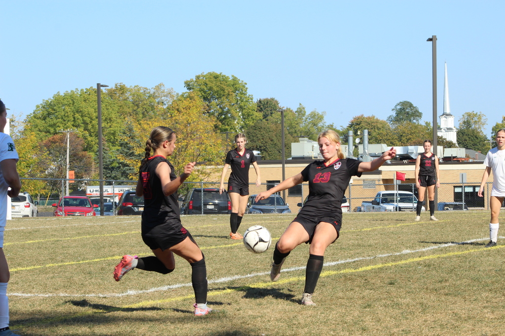 girls playing soccer on the field