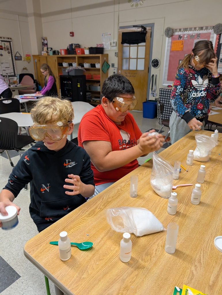 students at table doing science experiments