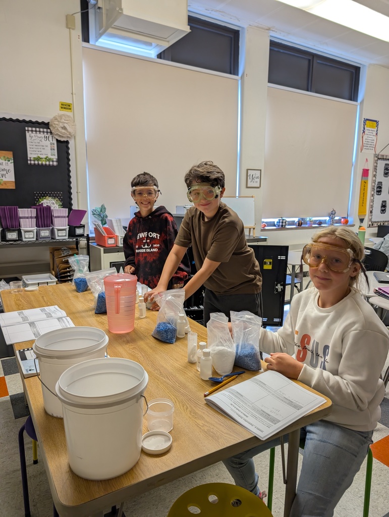 students at table doing science experiments