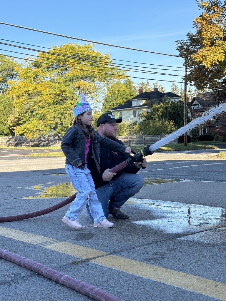 student using firehose with firefighter