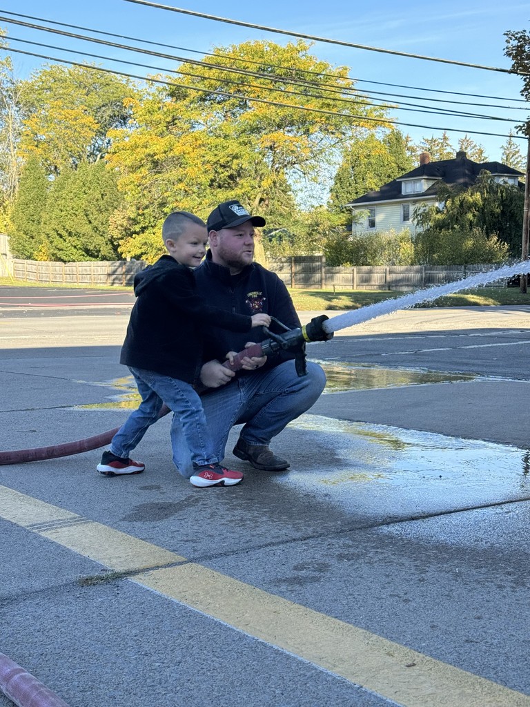 student using firehose with firefighter