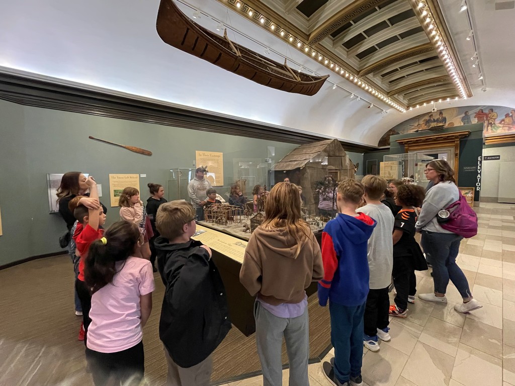 students looking at museum exhibit