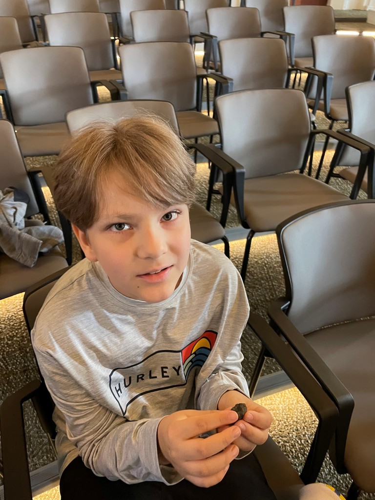 boy holding artifact