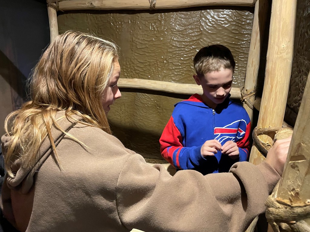 two students looking at museum exhibit