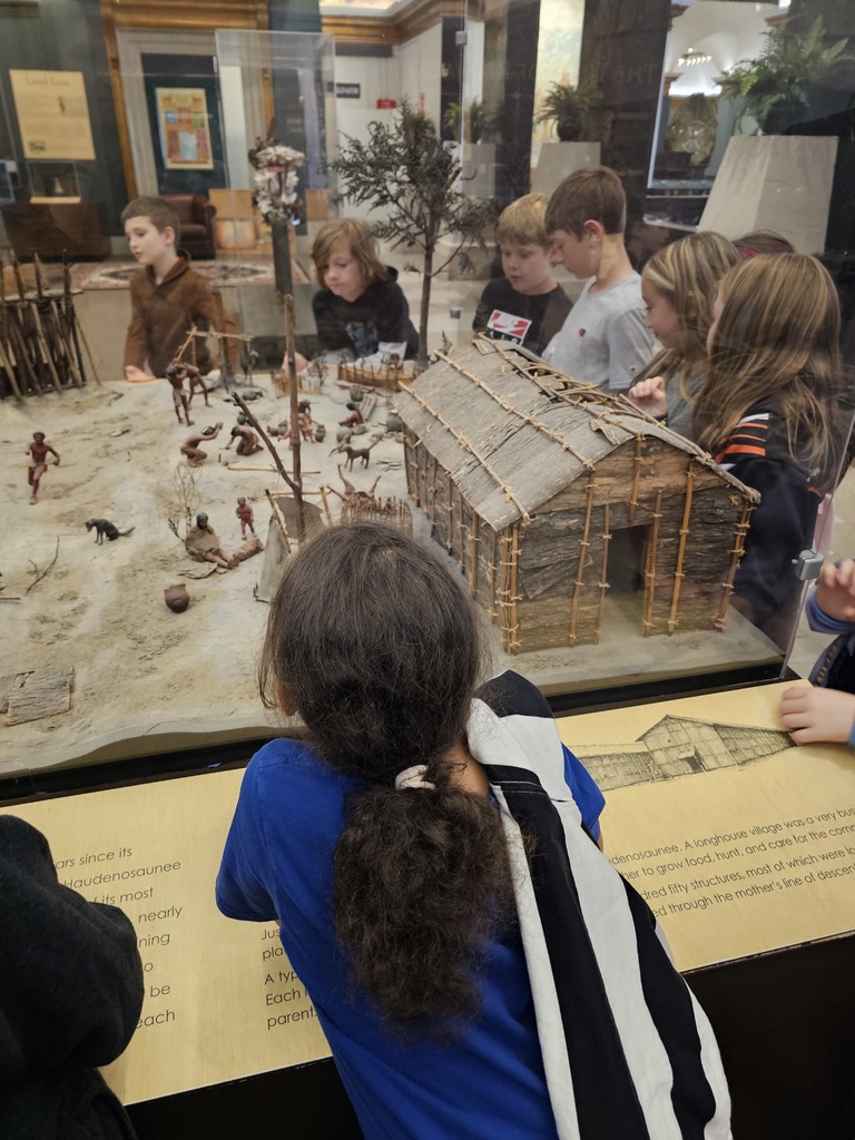students looking at diorama in museum