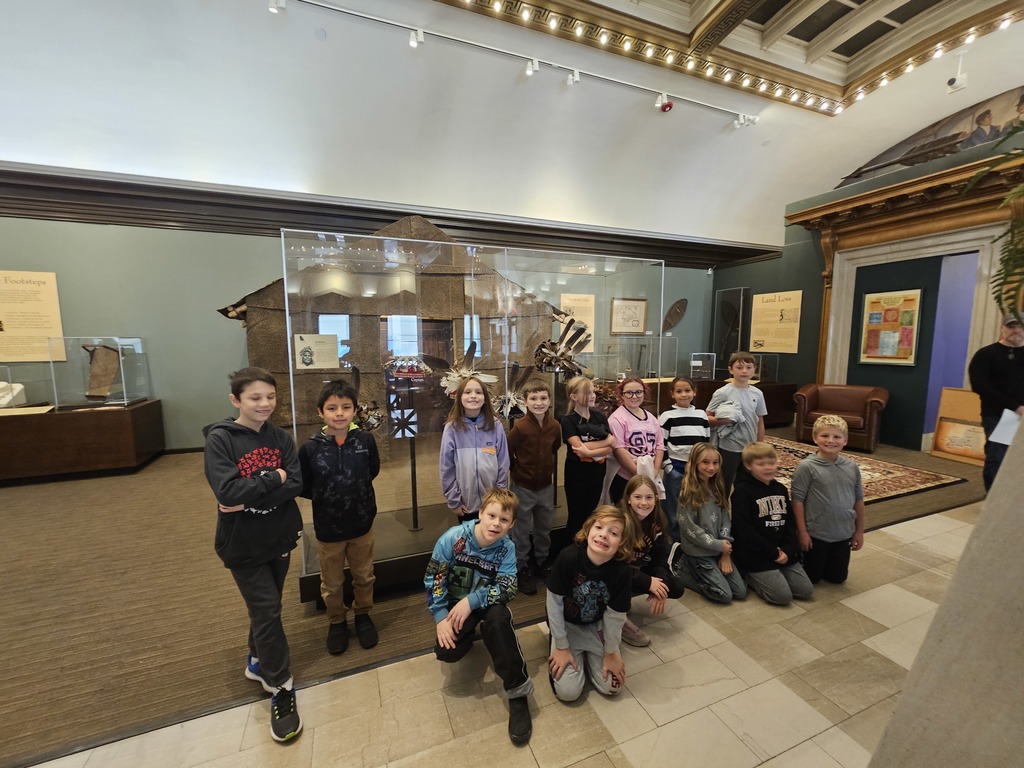 students posed in a group in the museum