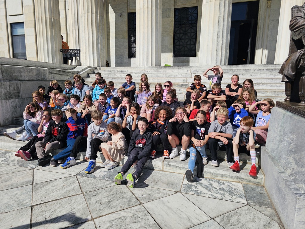 students sitting on steps of museum