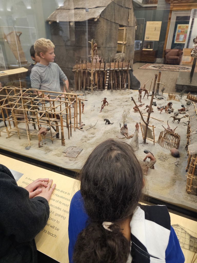 students looking at diorama in museum