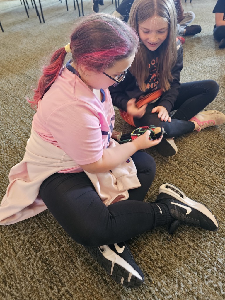 student holding a doll in the museum