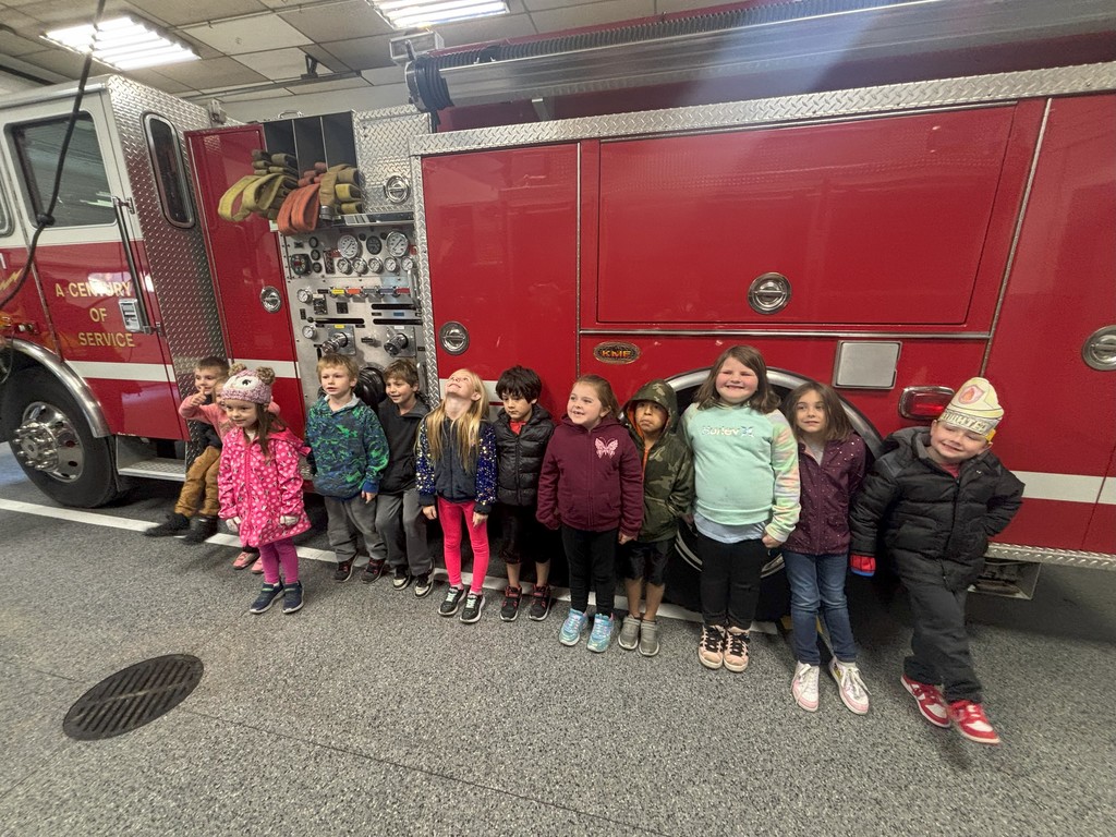 students lined up next to fire truck