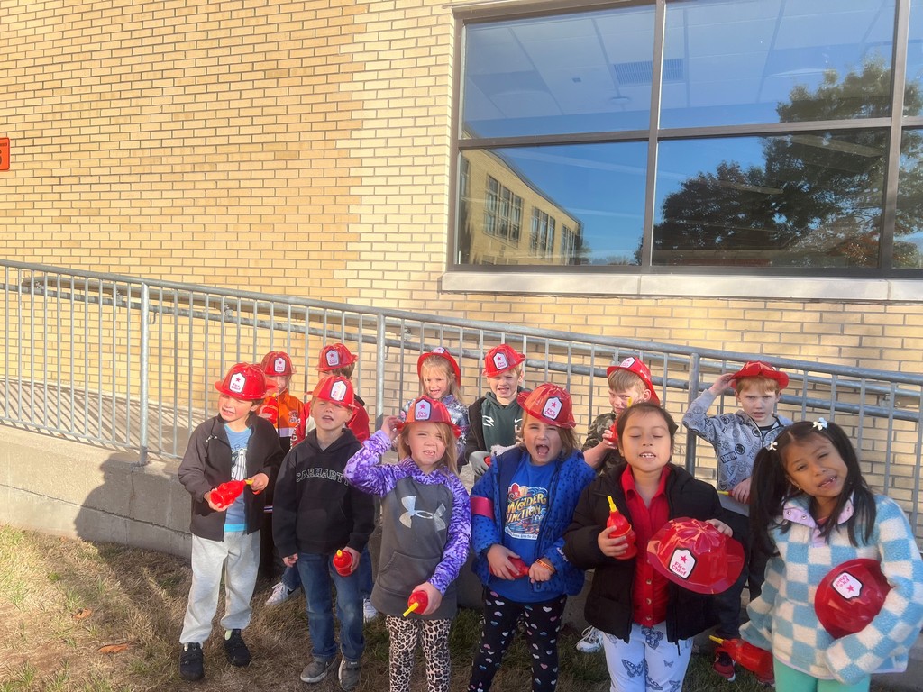 group of kids wearing firemen hats