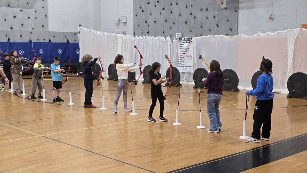 students using bows and arrows in gym