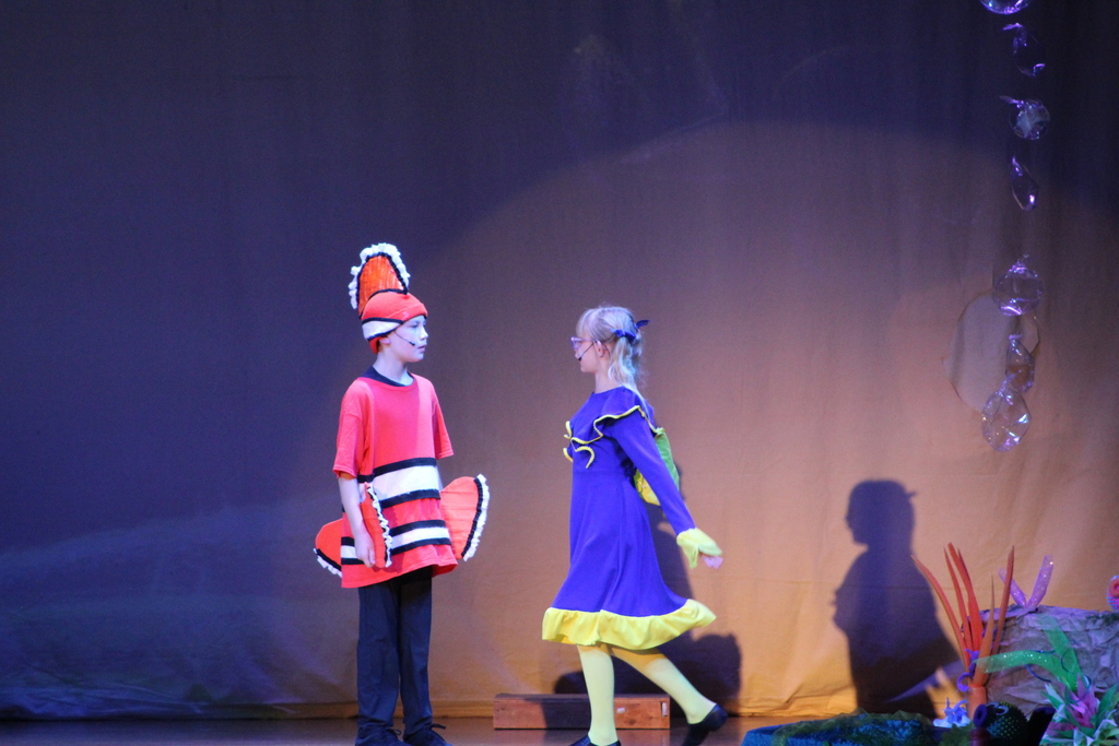 two students acting on stage