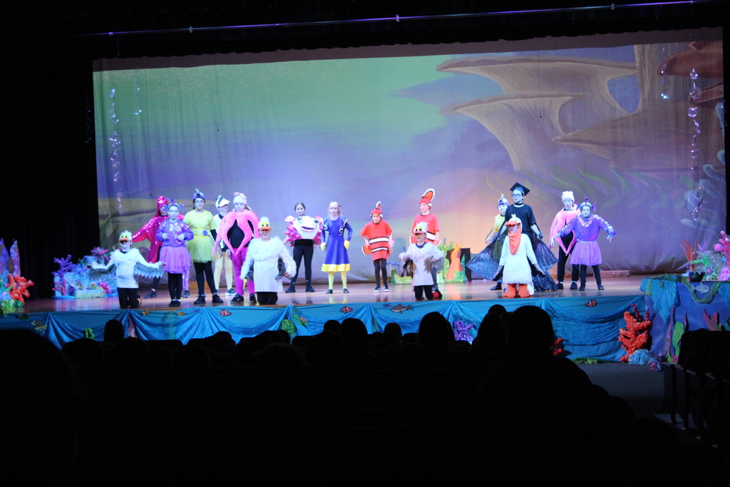 students on stage in costumes