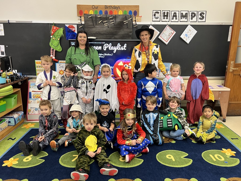 students and teachers in classroom wearing Halloween costumes
