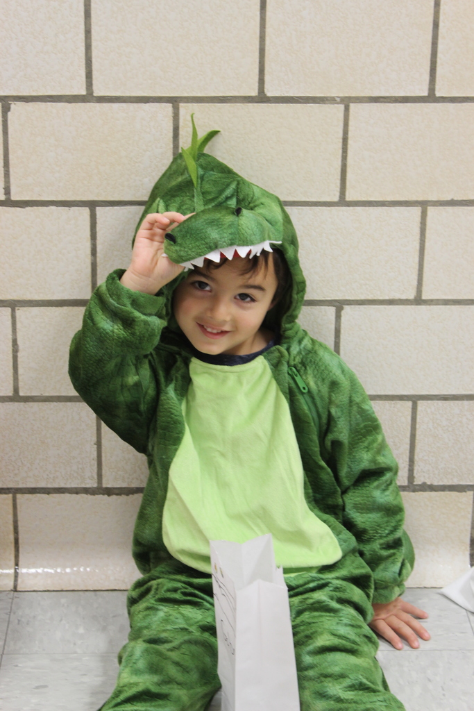 boy in costume sitting on the floor