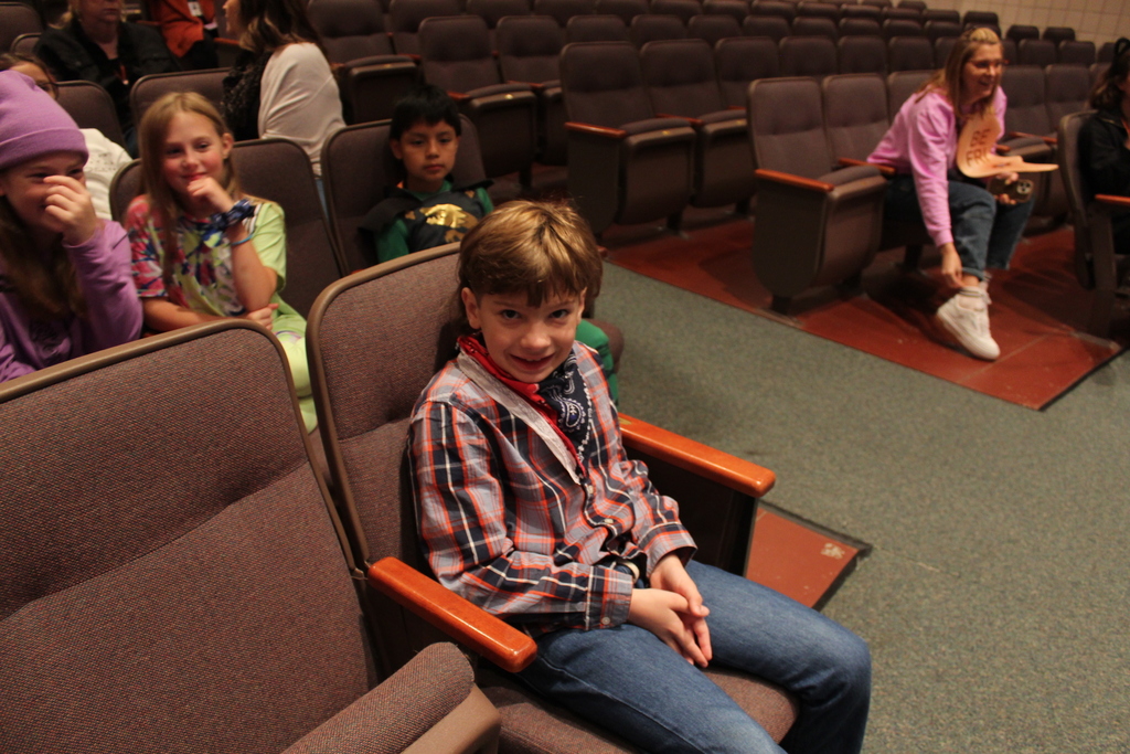 students sitting in the auditorium in their costumes