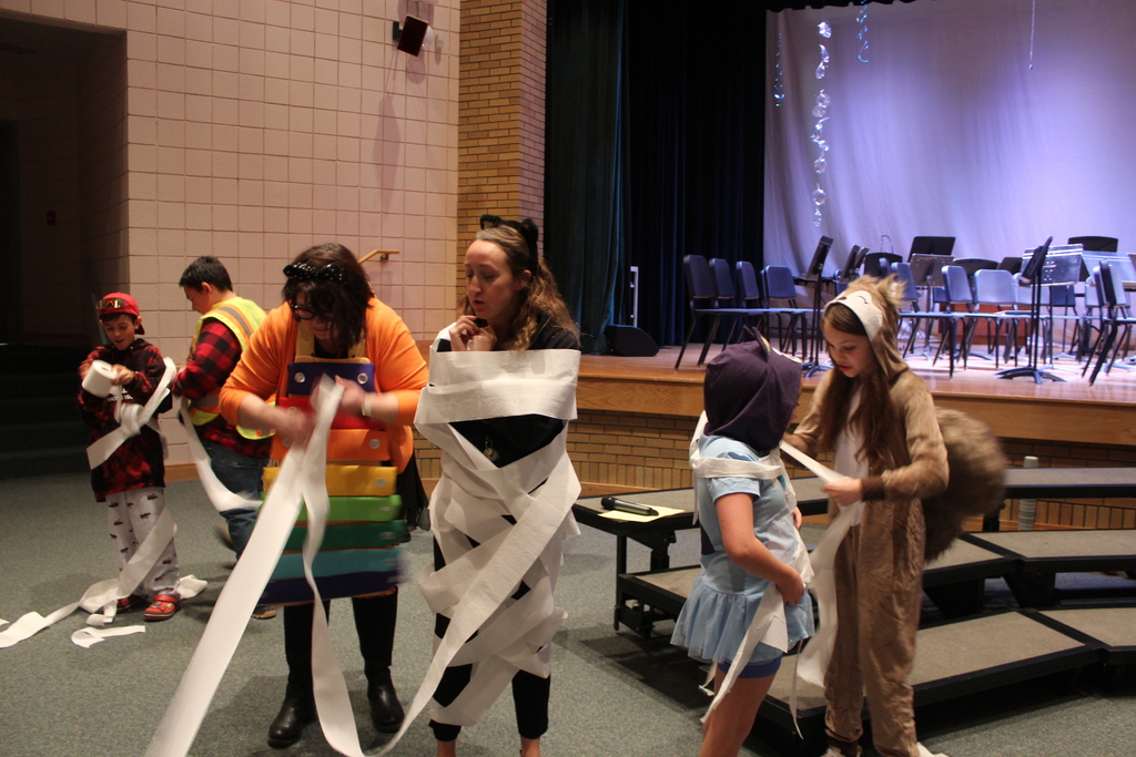 students wrapping each other up as mummies with toilet paper