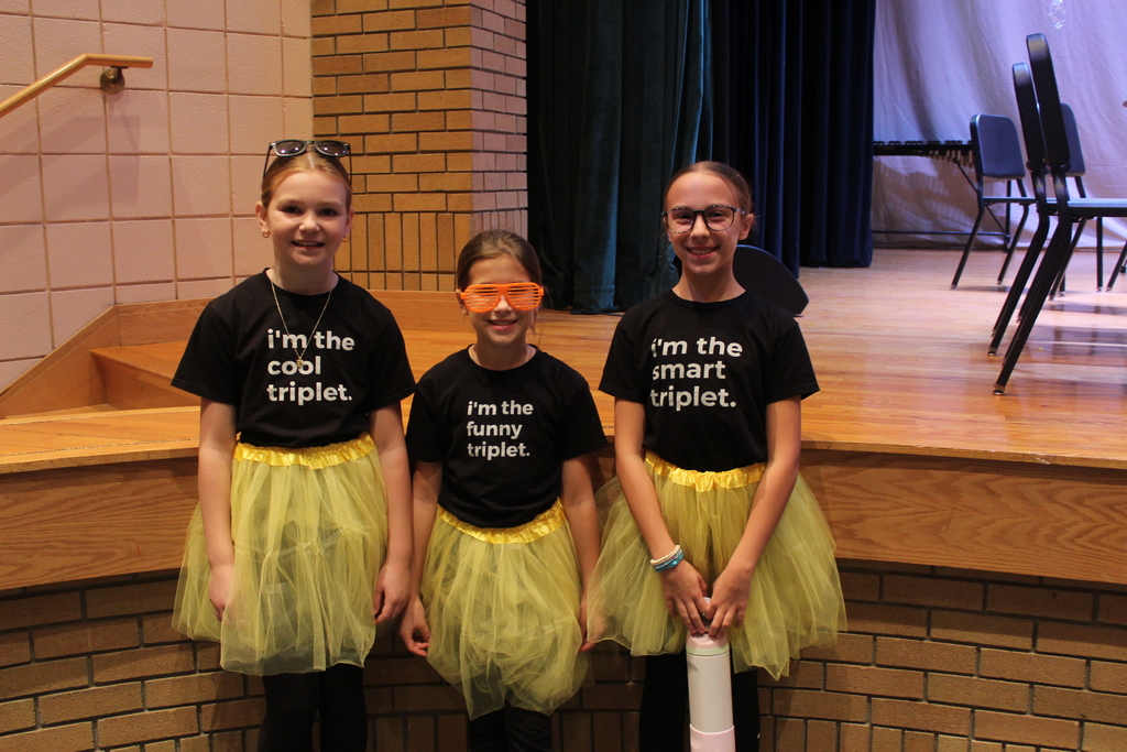 three girls dressed as triplets