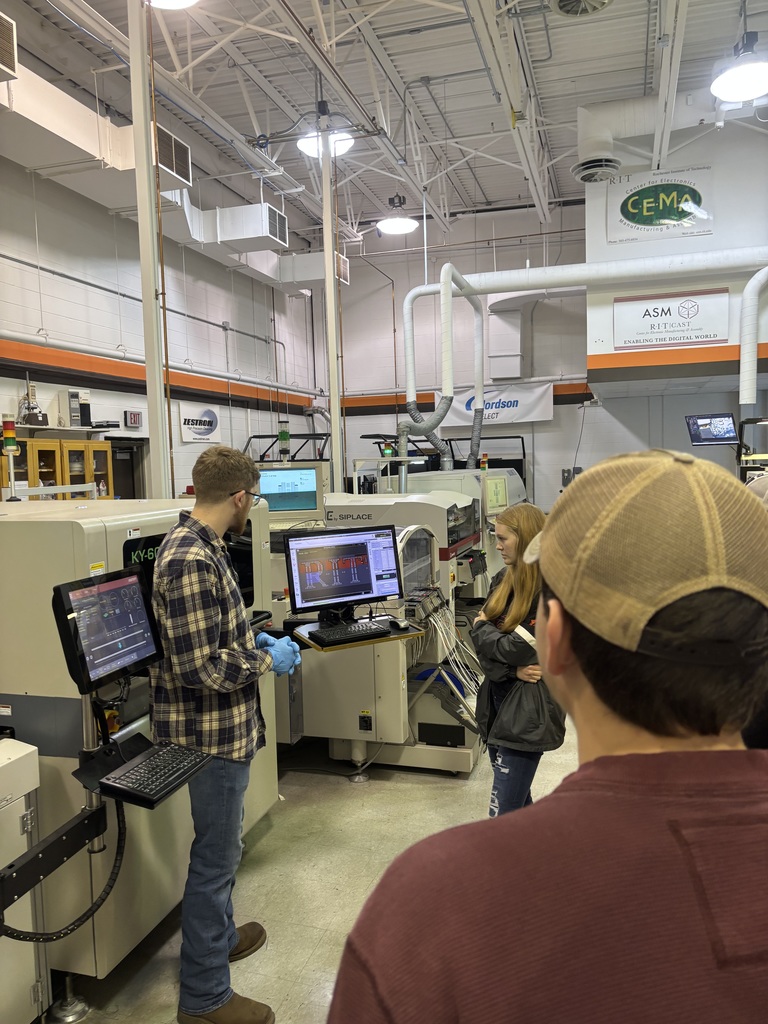 students listening to a presenter in a tech workshop