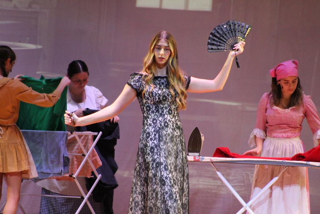 four students acting on stage