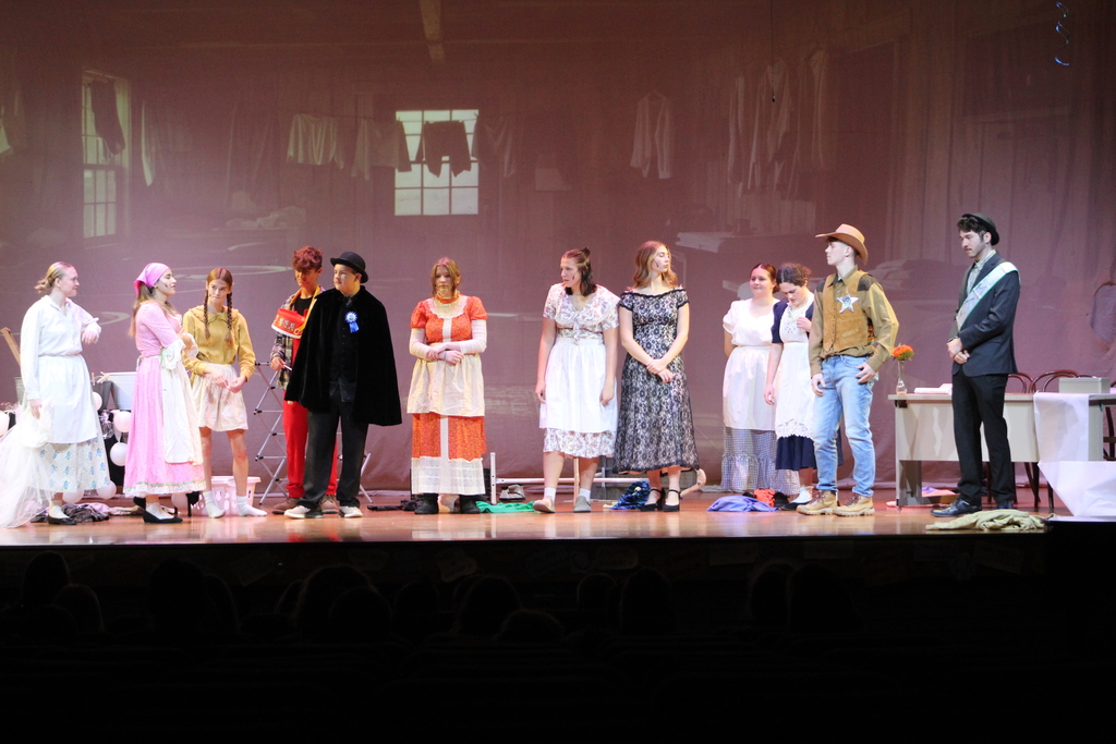 students standing on stage in costume