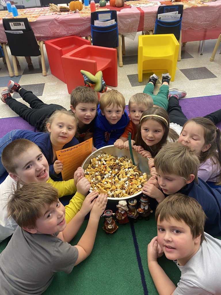 students lying on rug around bowl of food